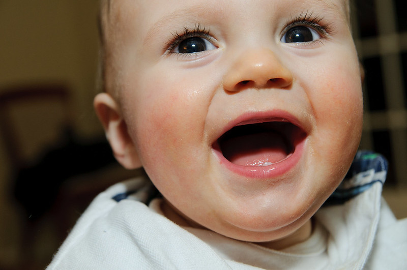 infant toddler with first tooth ready to visit dentist