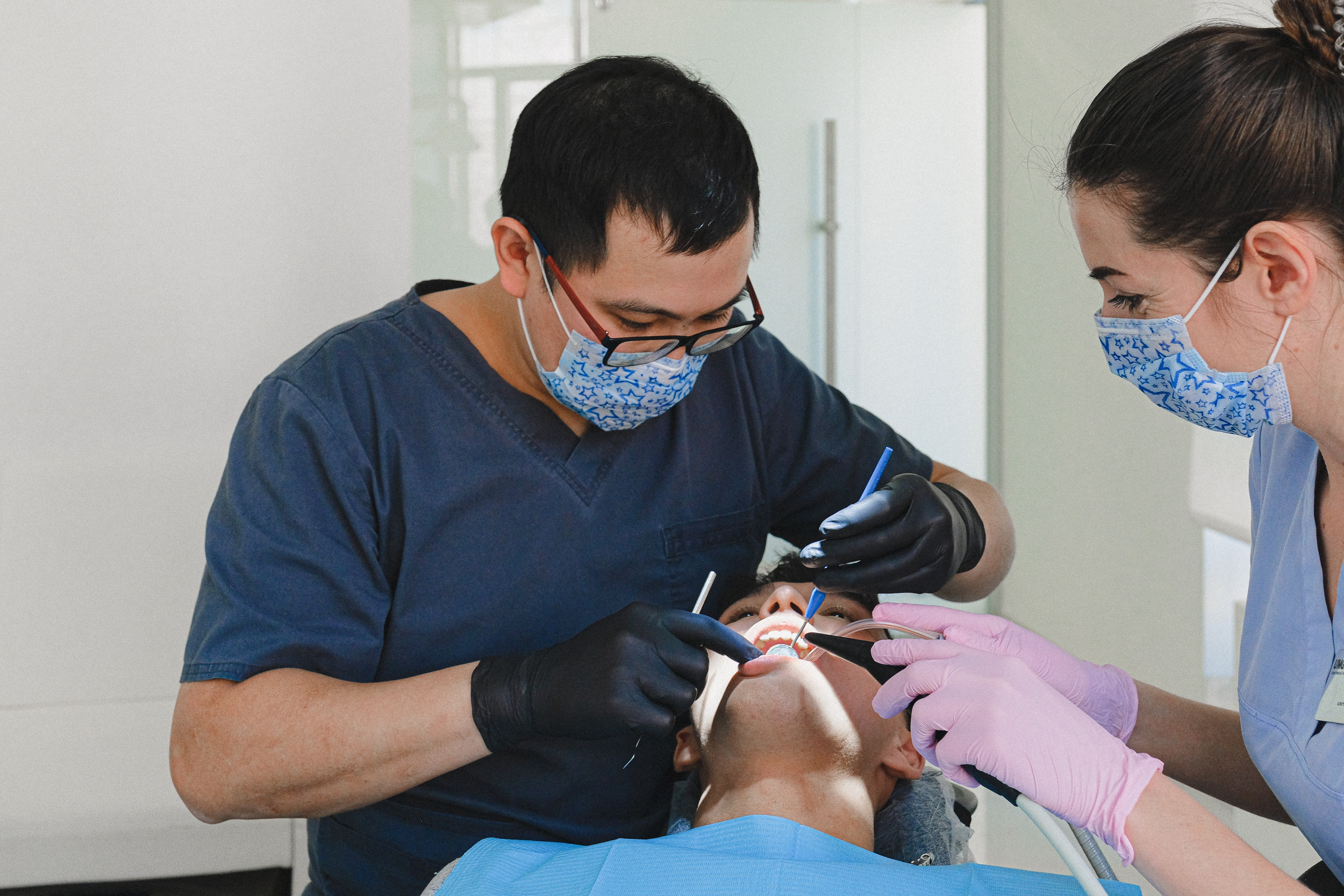 Dentist checking behind the teeth for plaque buildup during a dental cleaning