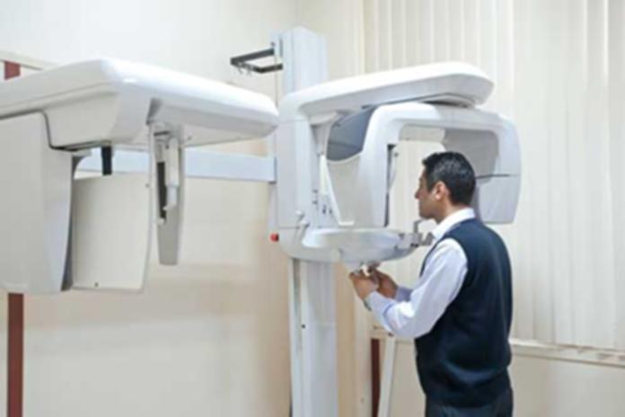 Man demonstrating the use of a dental x-ray radiograph