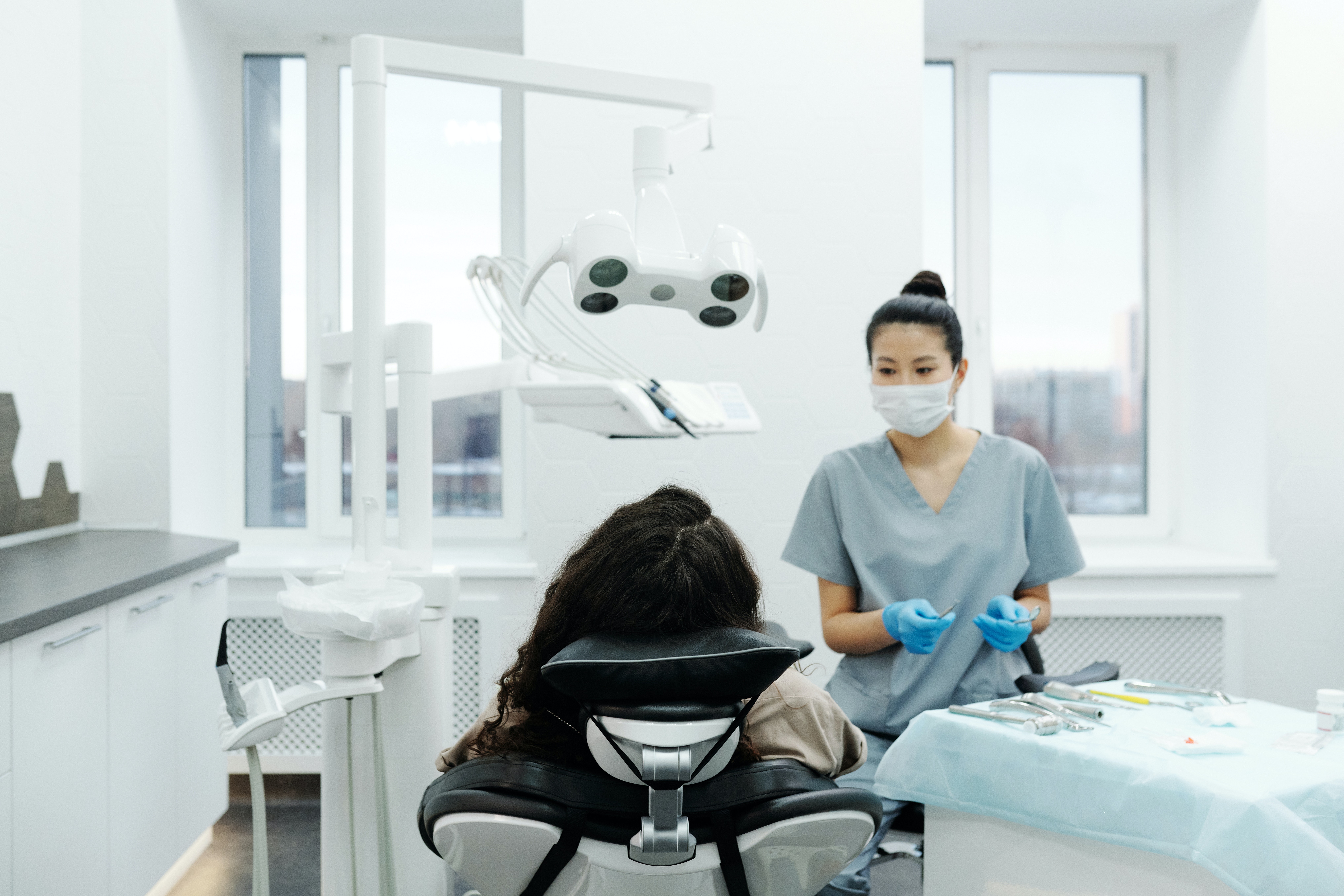 Dentist talking to a patient about causes of a possible TMJ disorder