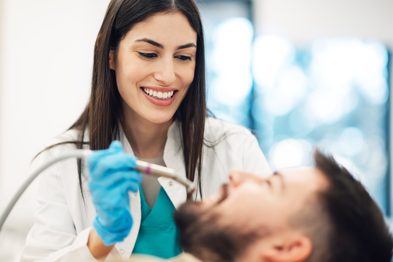 This image has an empty alt attribute; its file name is female-dentist-performing-dental-procedure-on-male-2025-04-03-21-15-19-utc.jpg