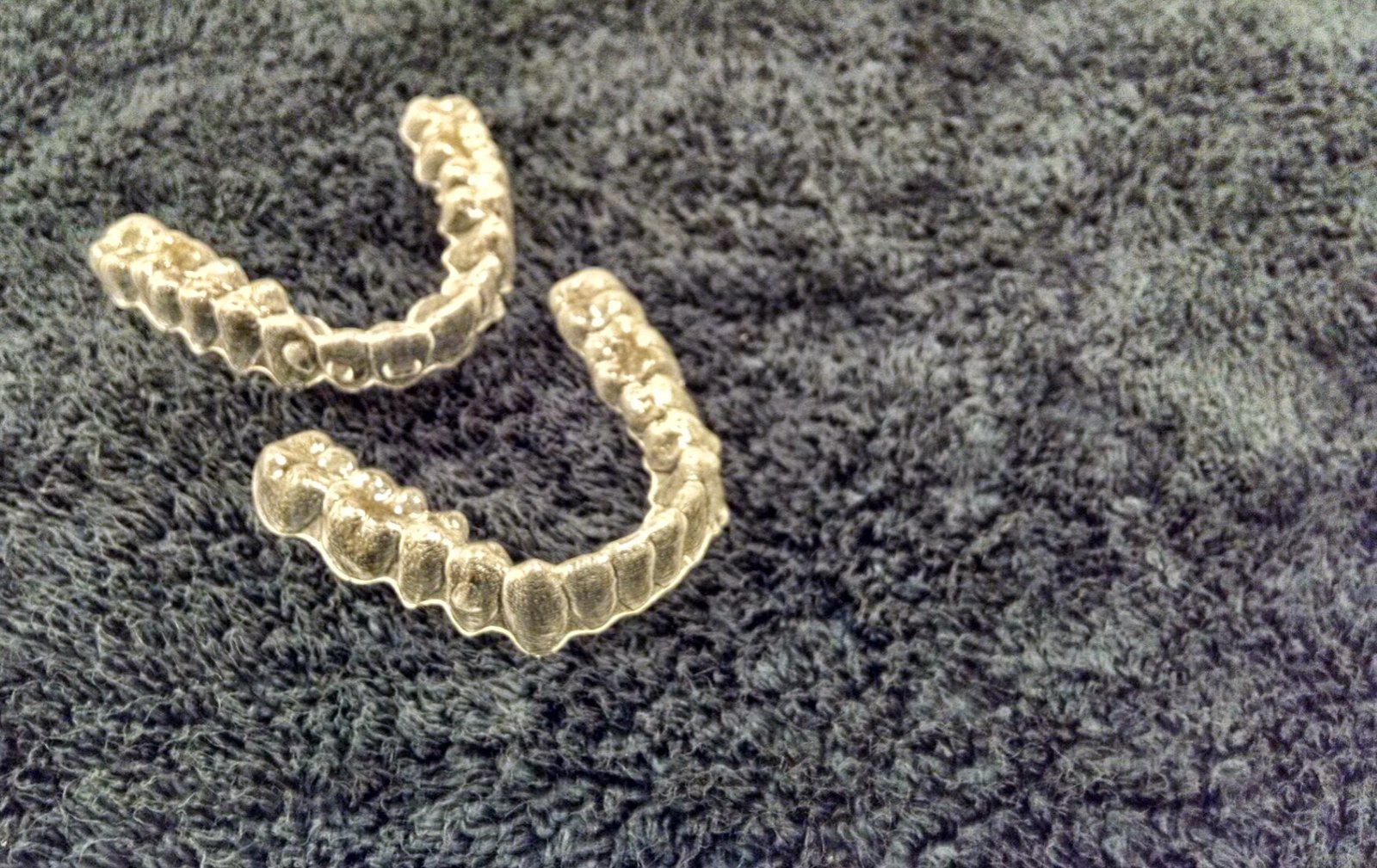 Yellowed Invisalign trays improperly placed on carpet instead of in their case while eating