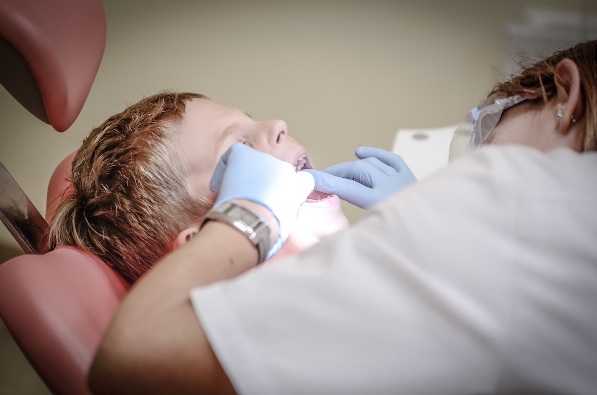 Young child getting sealants put on his baby teeth