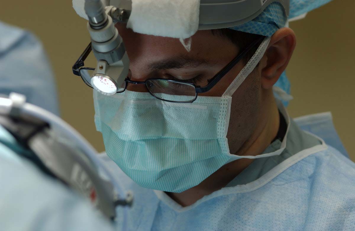 Oral surgeon performing a dental implant procedure