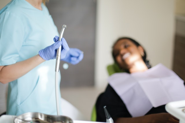 Dentist preparing to use tooth polish on a patient during a dental cleaning