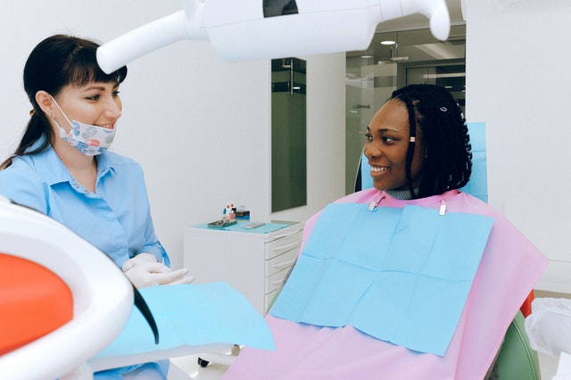 Woman talking to dentist about a cavity