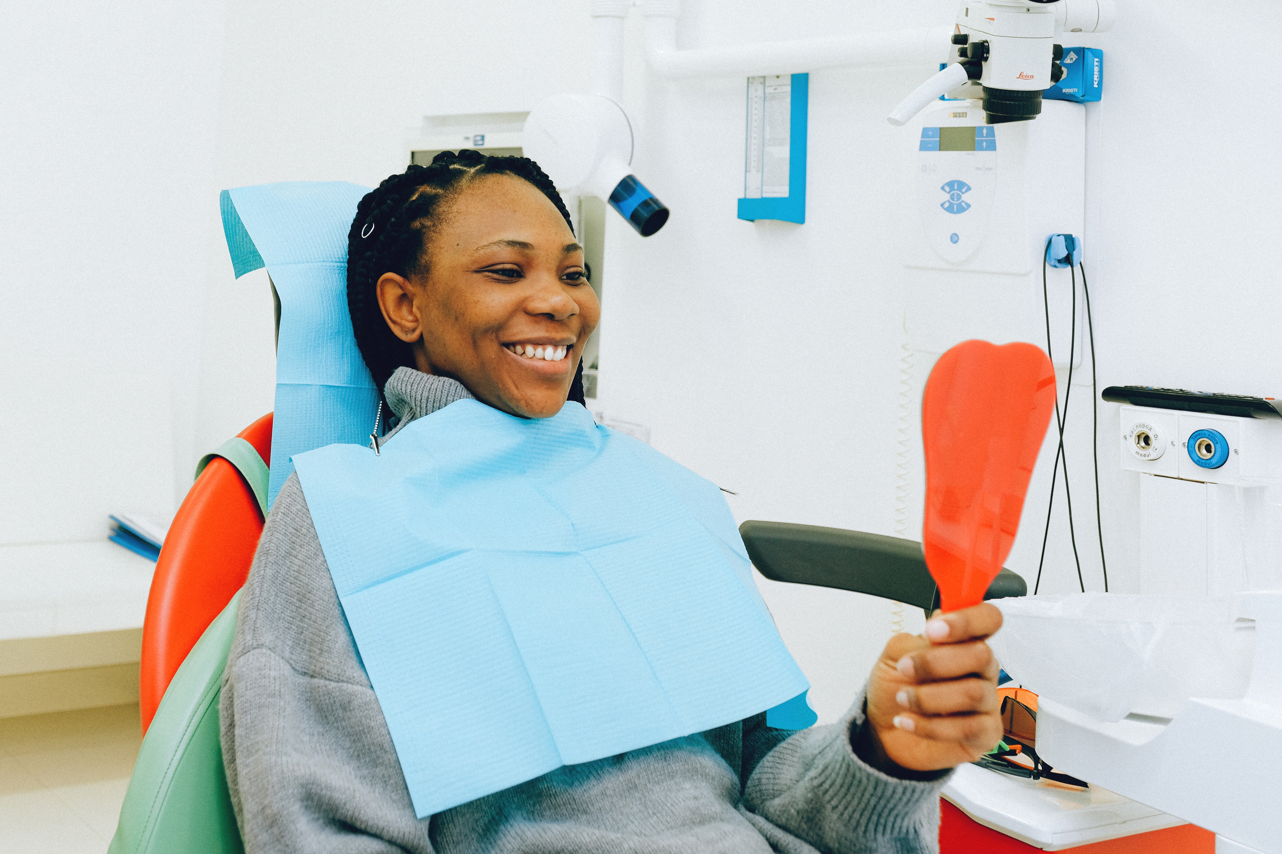 Woman admiring teeth after a dental cleaning