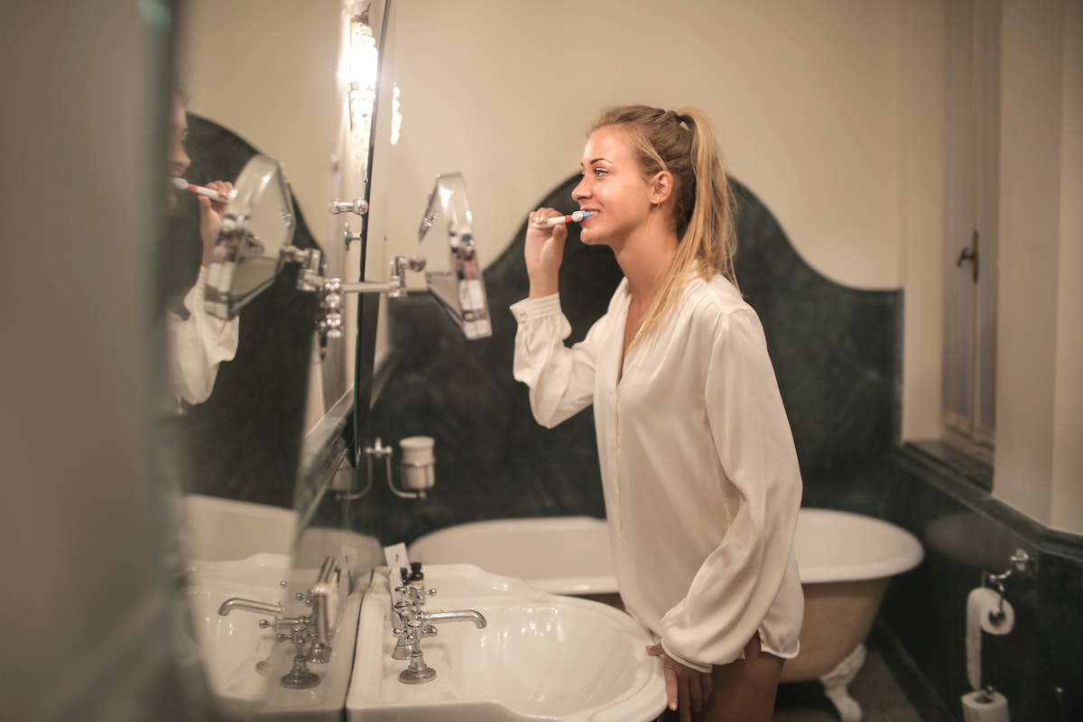 Woman brushing teeth to prevent cavities